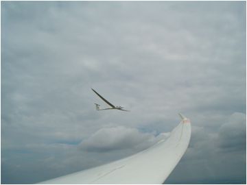 Two gliders in flight, wing of a soaring sailplane